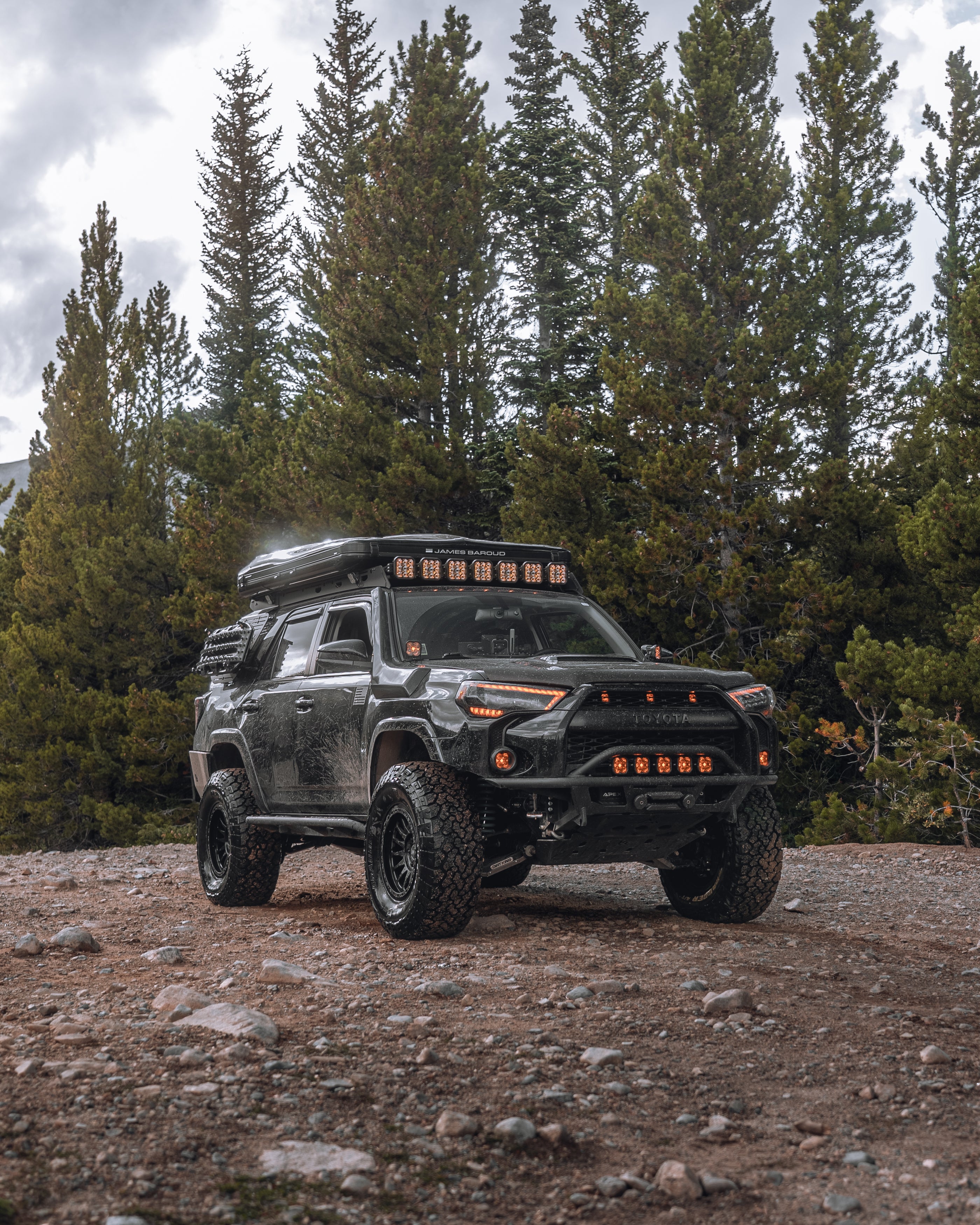 Black overlanding 4Runner with James Baroud Tent in the forrest