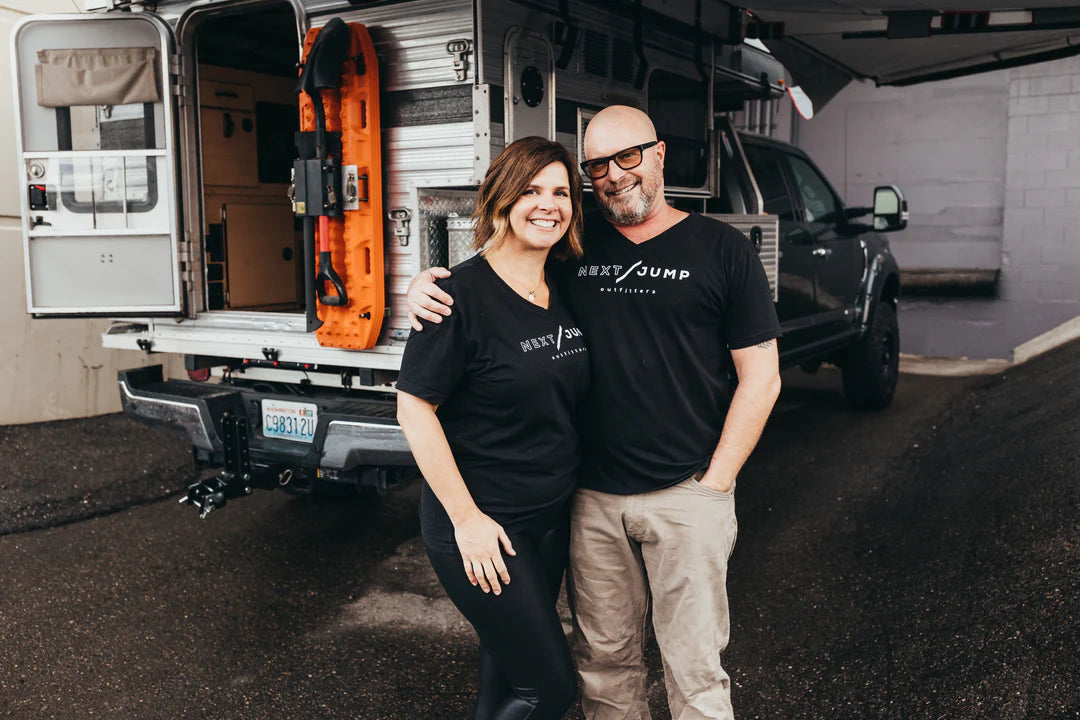 Woman and man business owners standing in front of Next Jump Outfitters in Tacoma, WA 
