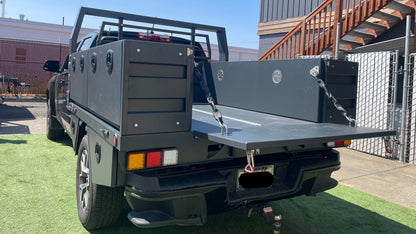 Truck with a flatbed and open tailgate